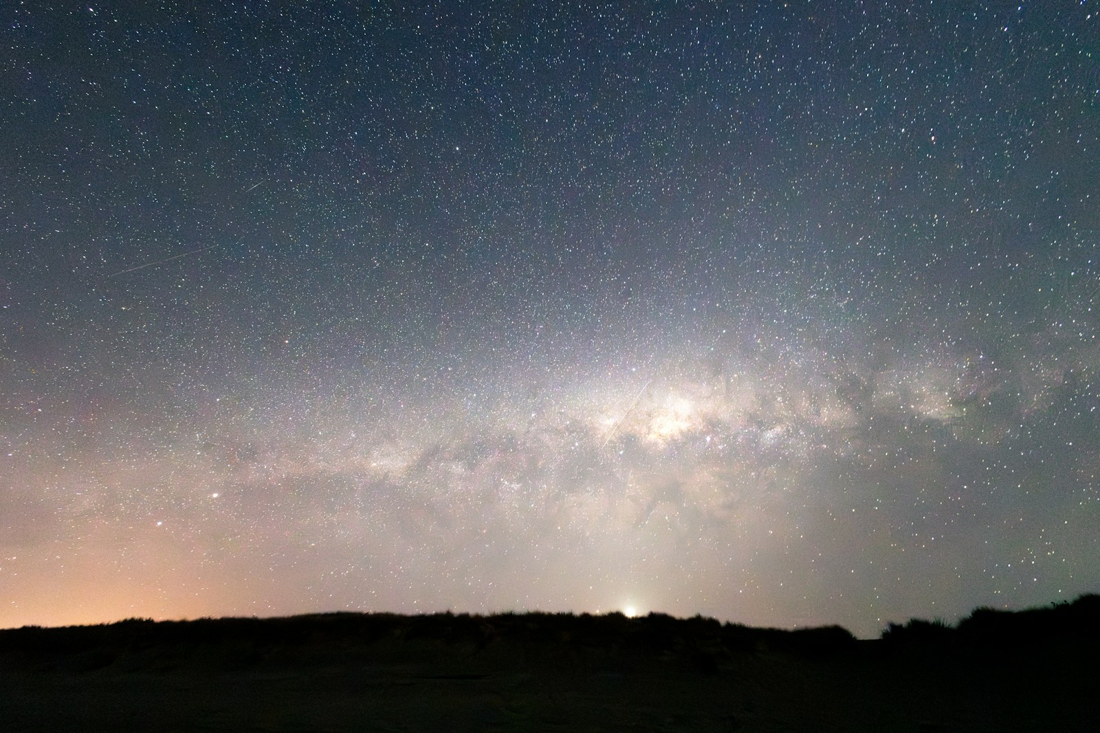 Orion constellation over a dark landscape
